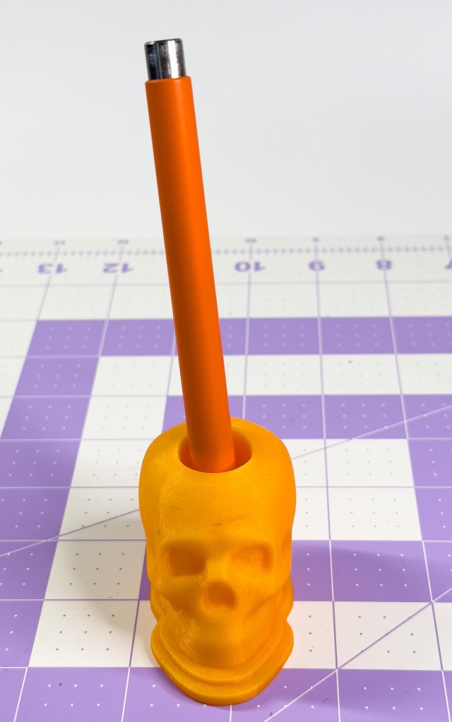 Studio Neat Mark One in a 3D printed skull holder.