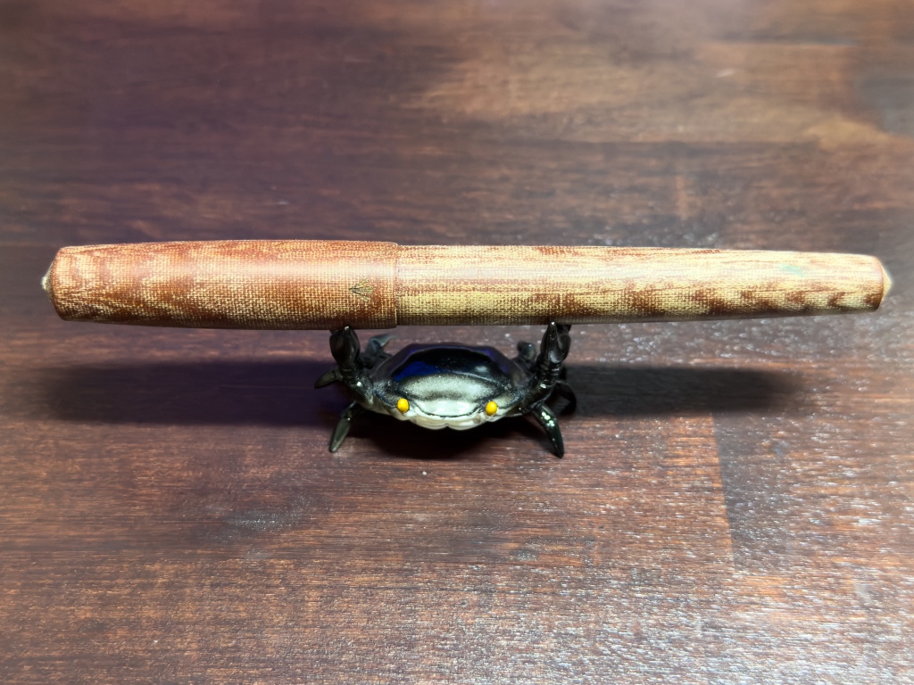 Gravitas Micarta with the cap closed on a crab shaped pen stand