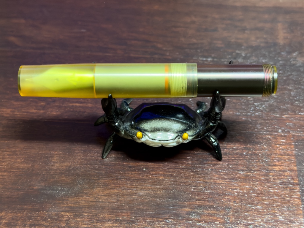 Gravitas Quark with the cap closed on a crab shaped pen stand